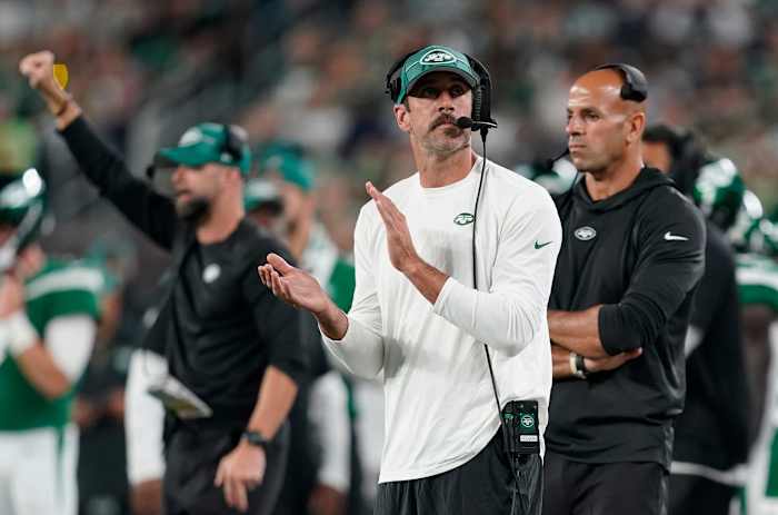 Inactive for the preseason game against the Bucs, Jets' QB Aaron Rodgers claps on the sideline